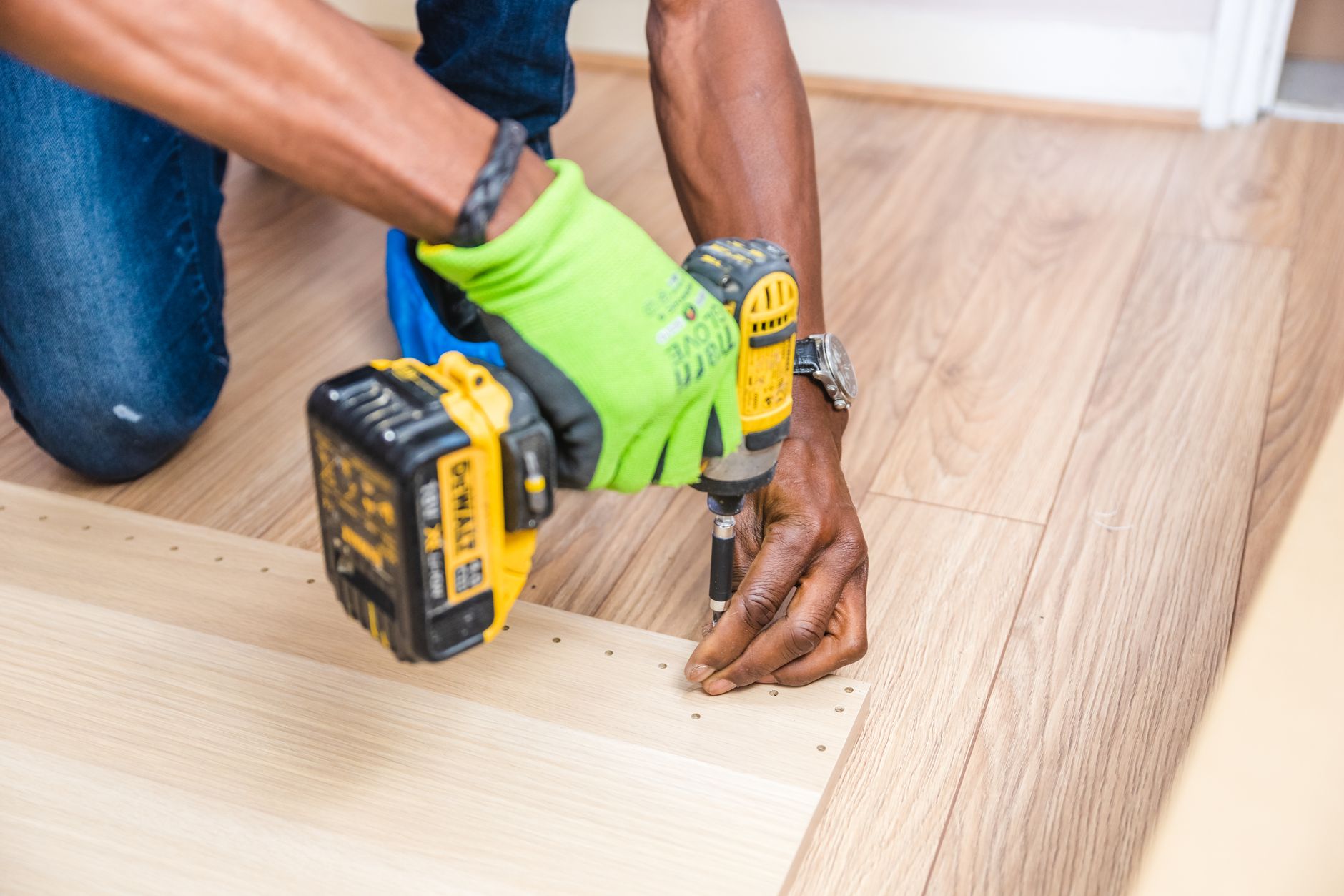 Handyman drilling wood indoors with a cordless drill during a Port St Lucie repair job